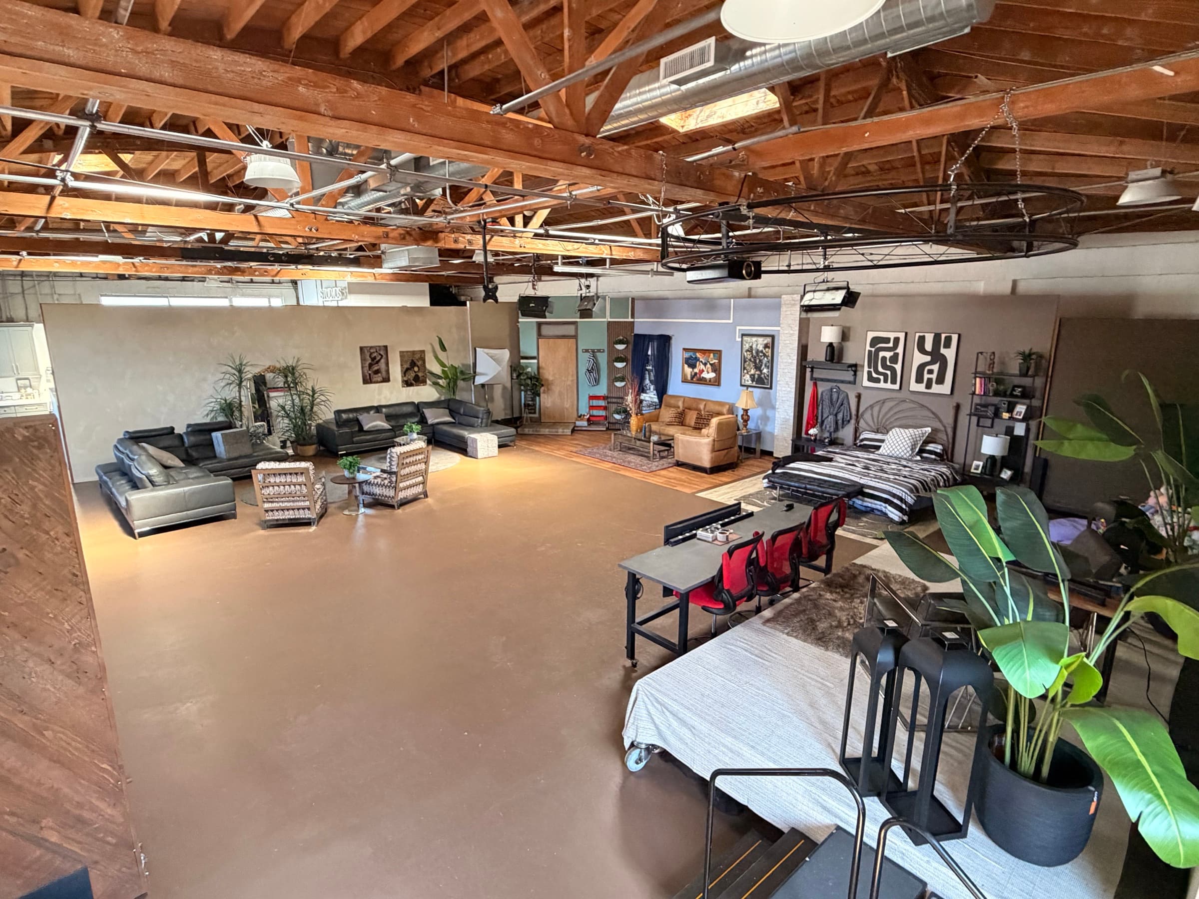 The ACT Immersively floor from above: living room and bedroom standing sets under open timber beams